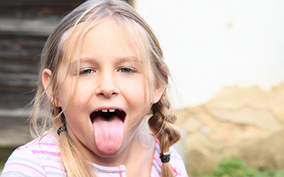 A young girl sticking her tongue out