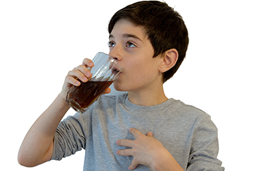 Young boy drinking a soda