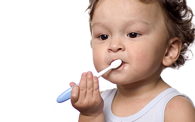 Young child brushing teeth