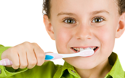 Young child brushing his teeth