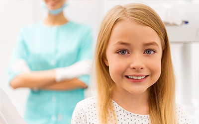A young girl smiling in the dental office