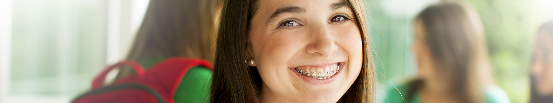 Young girl smiling with dental braces