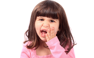 Child with a sensitive tooth
