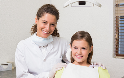 A dentist with a girl smiling