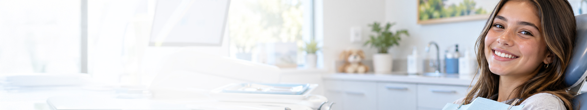 Young girl sitting in dental chair smiling with dental braces in Parker, CO